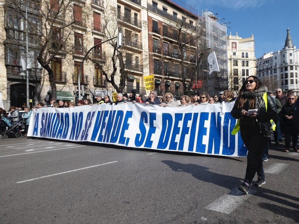 Cabecera de una manifestación por la sanidad pública en la calle de Alcalá de Madrid con la pancarta «La sanidad no se vende, se defiende»